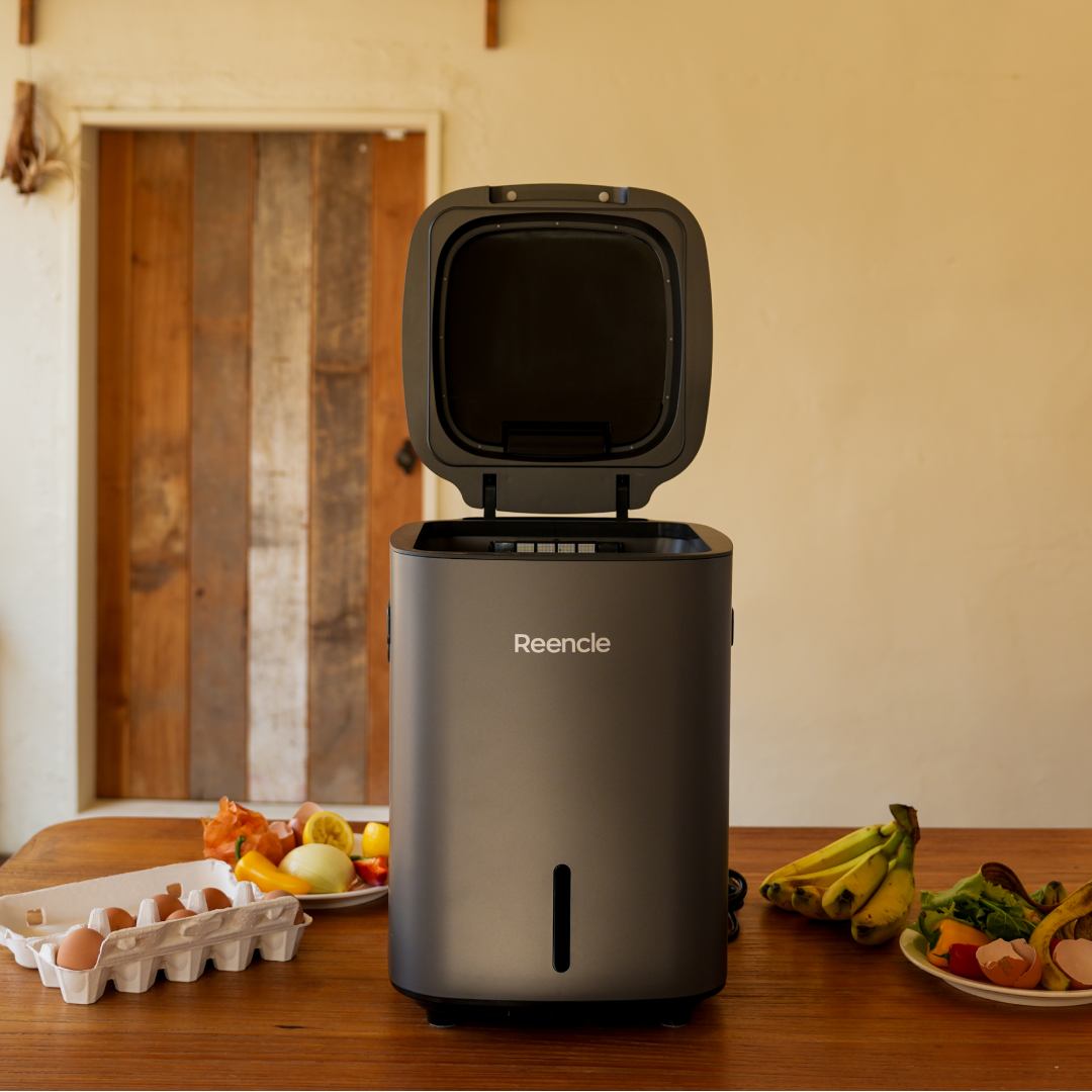 Reencle kitchen composter with food waste being added