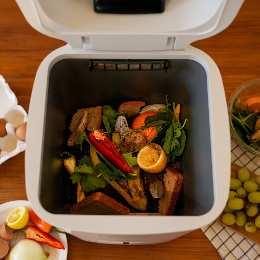 open reencle home composter filled with food waste